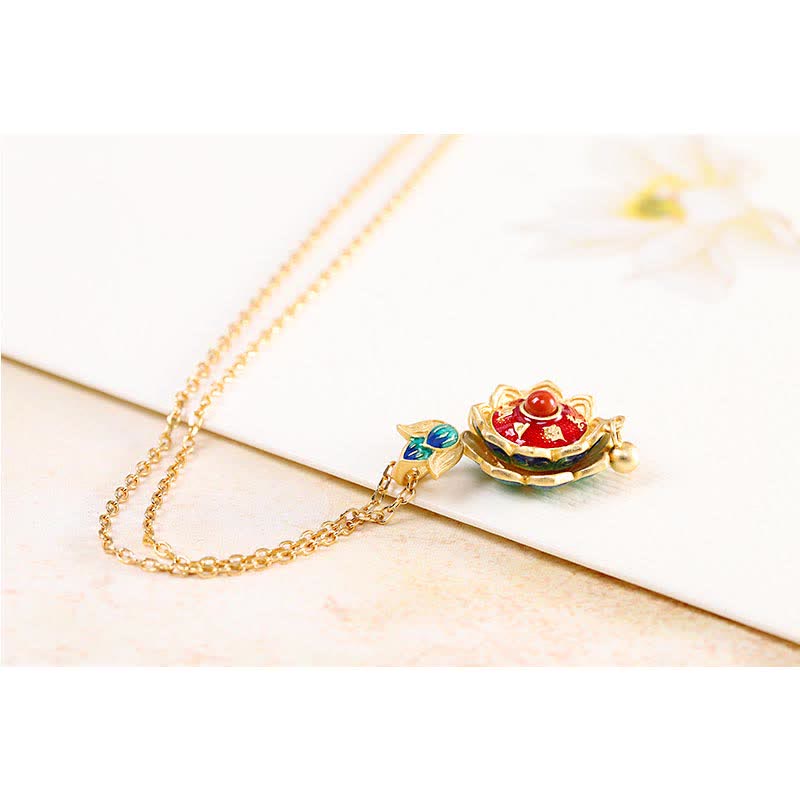 Silver Lotus Amulet – tiered gold lotus dome with red enamel on marble, sacred