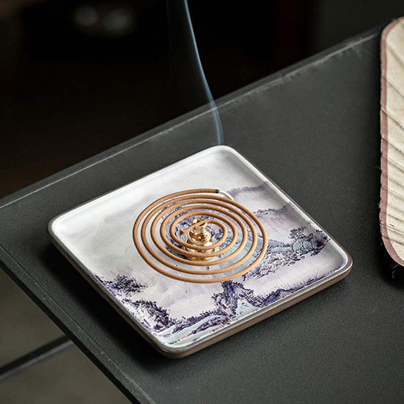 Blue White Incense Plate – Coil incense with rising smoke on traditional landscape ceramic dish, dark setting