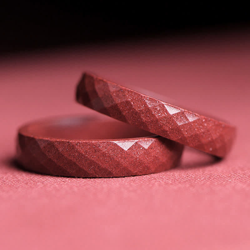 Cinnabar Om Mani Padme Hum Blessing Ring – two goldstone rings with diagonal faceted cuts, copper shimmer, pink fabric surface