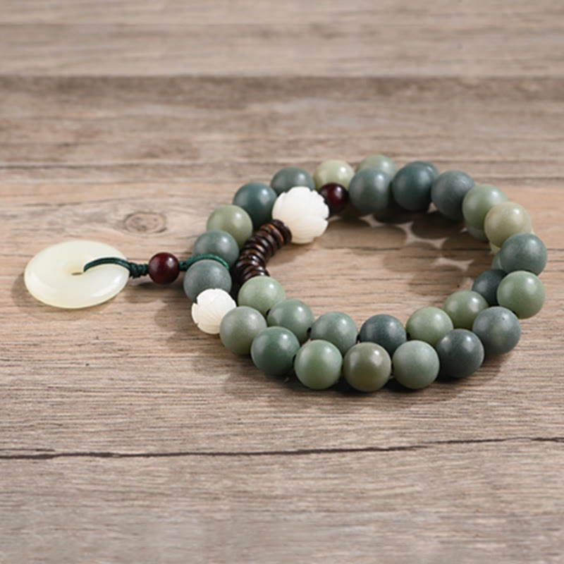 Cyan Bodhi Seed Jade Peace Buckle Bracelet - natural green bodhi seed wrist mala on weathered wood plank