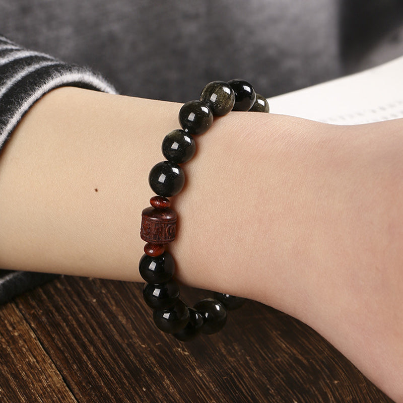 Gold Sheen & Rainbow Obsidian Fu Bracelet – worn on wrist against dark wood, beaded jewelry