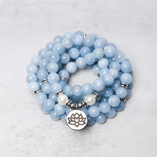 108 Mala Aquamarine Bracelet – coiled blue beads with silver lotus charm, peaceful