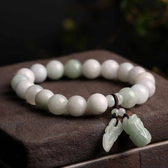Natural Jade Pi Xiu Buddha Gourd Apple Success Bracelet – PiXiu and leaf charms on stone surface, healing jade