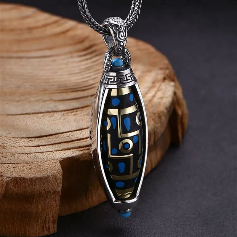Nine-Eye Dzi Bead Pendant - Three-quarter view revealing gold geometric maze and blue stone accents