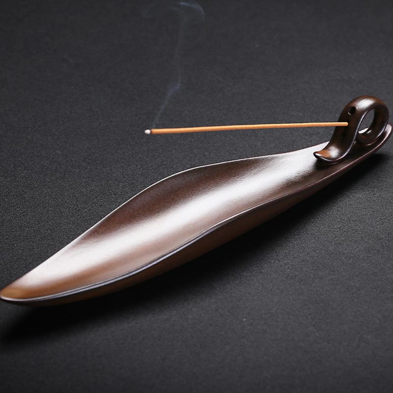 Ceramic Incense Burner – Glazed brown boat holder with lit incense wisp on dark backdrop, Calm