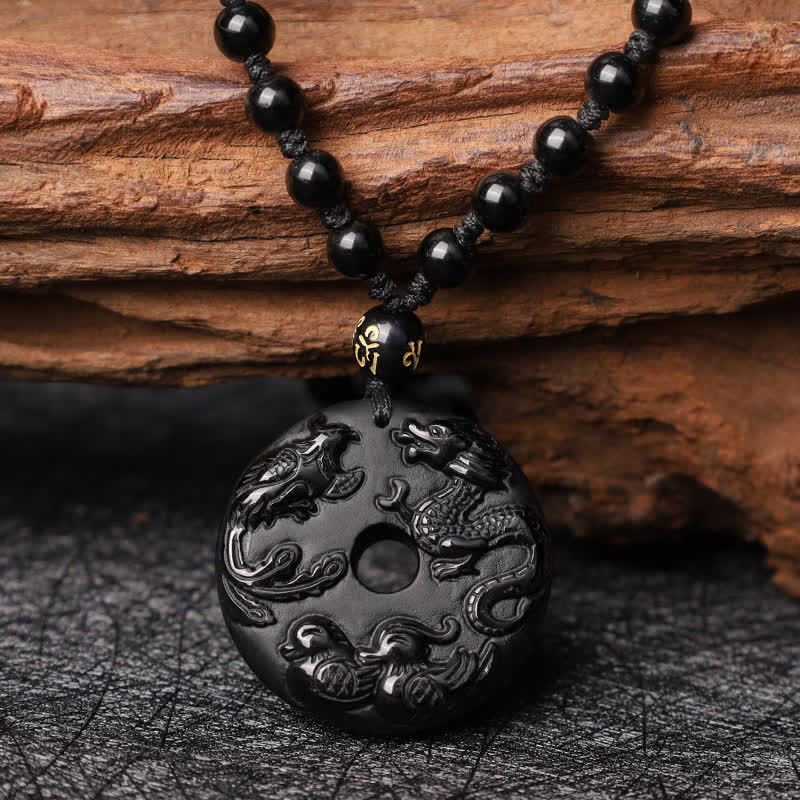 Black Obsidian Dragon Phoenix Pendant - Intricate dragon-phoenix relief on black obsidian with gold mantra bead, Strength
