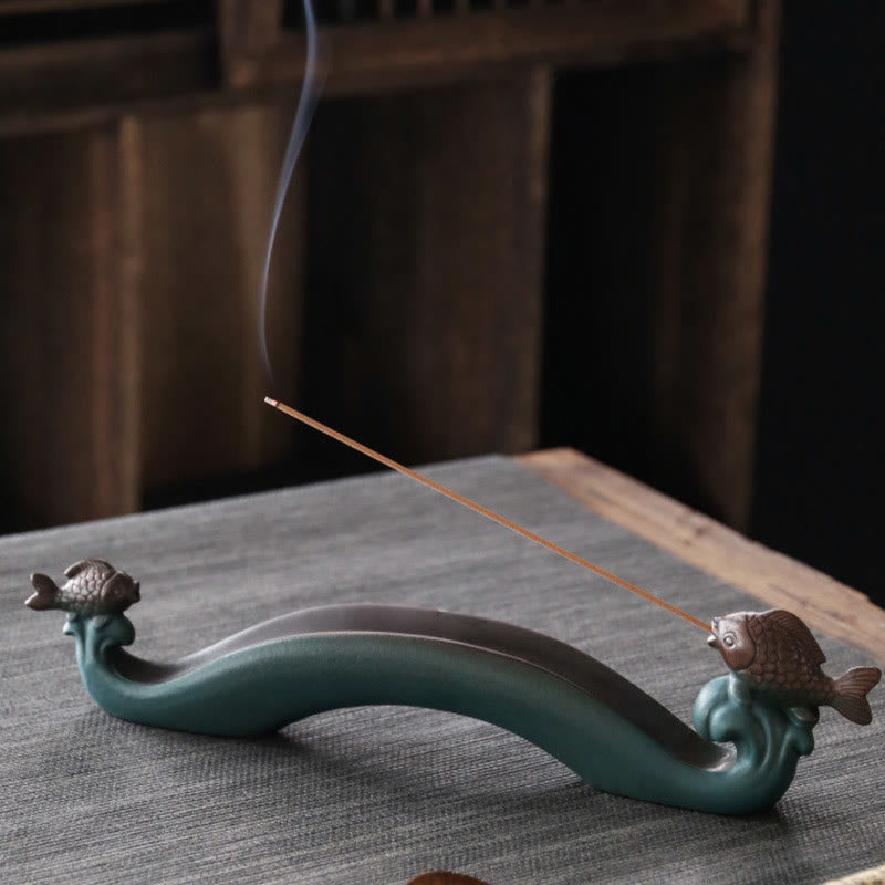 Double Koi Fish Mountain Incense Burner - teal koi holder with burning incense stick and smoke on gray fabric