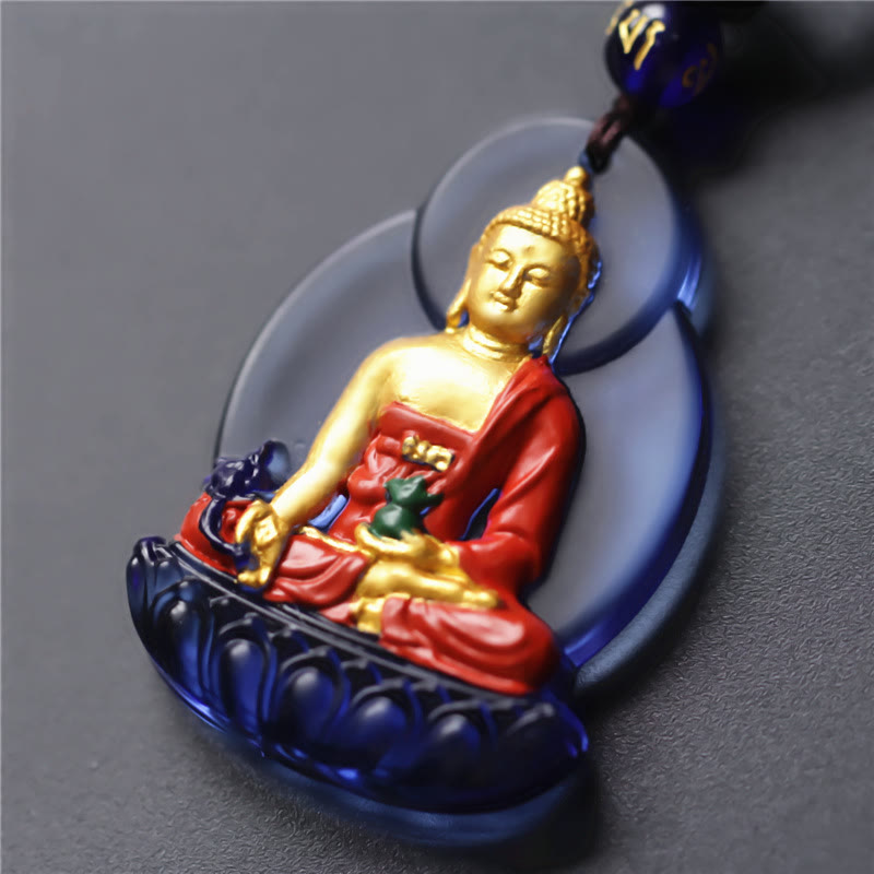 Liuli Crystal Medicine Buddha Pendant – closeup of blue liuli crystal with gold Buddha and red robe, macro detail