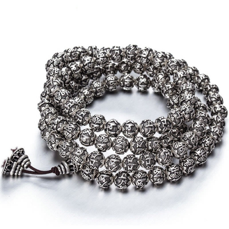Om Mani Padme Hum Bracelet – Coiled 108-bead silver mantra necklace on white, meditation mala