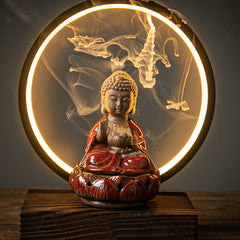 Buddha Lotus Backflow Incense Burner with glowing LED halo ring and cascading smoke on wood, meditation decor