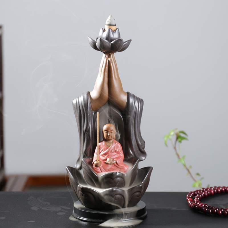 Buddha Lotus Incense Burner – Meditating monk in pink robes with drifting smoke, Sacred space