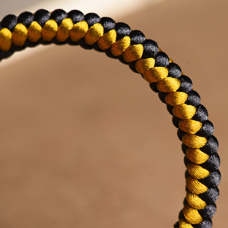 Tibetan Black Gold Dragon Scale Bracelet – macro close-up of spiral braid texture in black and gold, cord detail