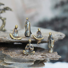 Mini Metal Meditation Buddha Decoration – five monks arranged on two-tier stone display, zen home decor