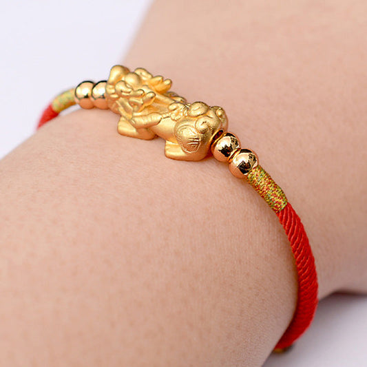 Gold-Plated PiXiu Red String Bracelet – gold PiXiu red bracelet worn on wrist, lifestyle fit shot, luck jewelry
