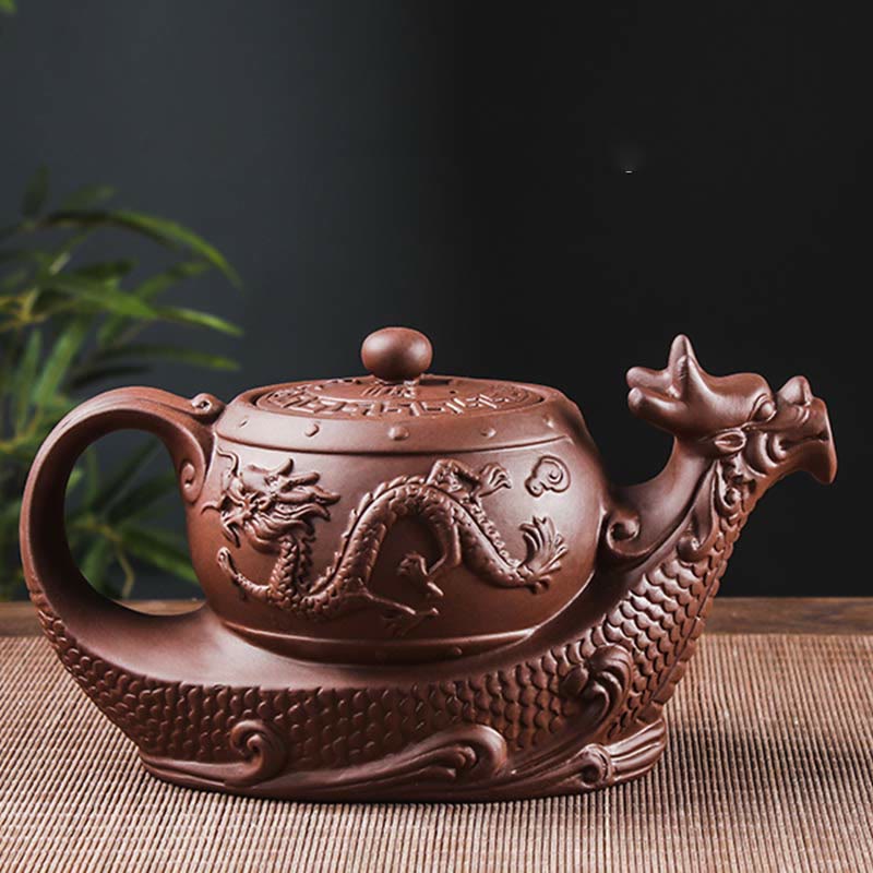 Vintage Dragon Auspicious Clouds Teapot – reddish-brown dragon teapot on woven mat with bamboo backdrop, moody dramatic light