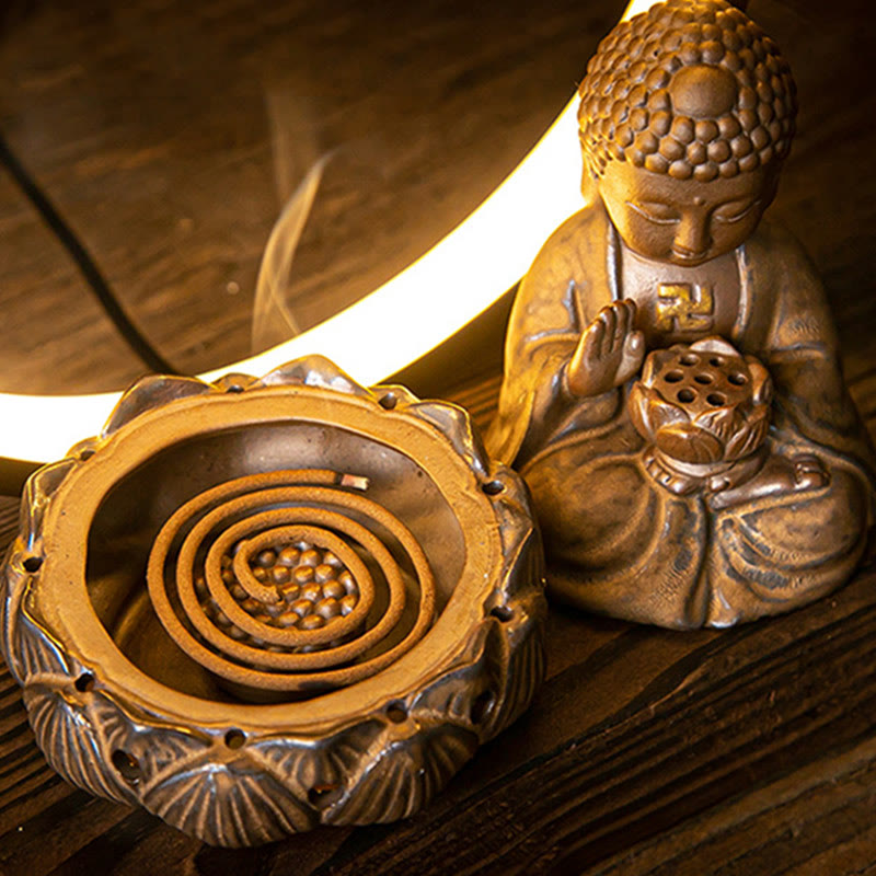 Lotus incense holder with burning coil and Buddha figure behind crescent LED light, wood slat surface, moody