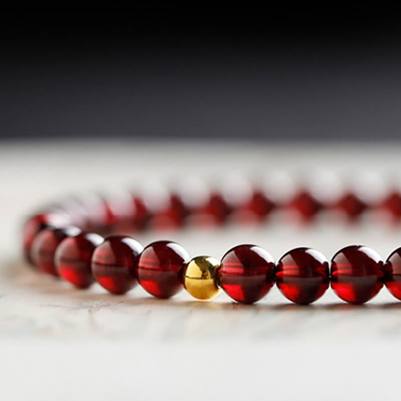 999 Gold Koi Bracelet – indoor natural light, garnet sparkle, koi fish wealth charm bracelet