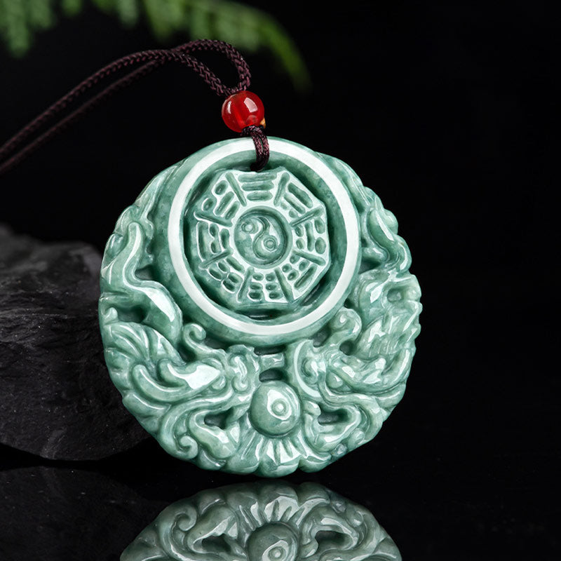 Dragon Jade Yin Yang Necklace – Green jade disc pendant on dark cord with red bead accent, dark brown wood grain background, three-quarter elevated