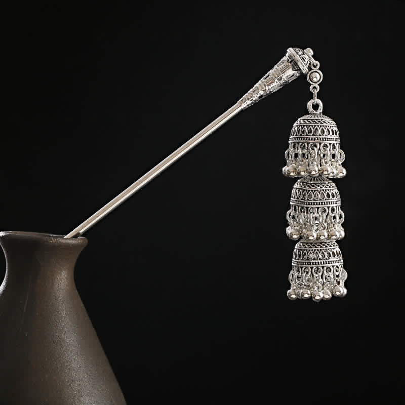 Bells variant triple bell tassel on black vase background