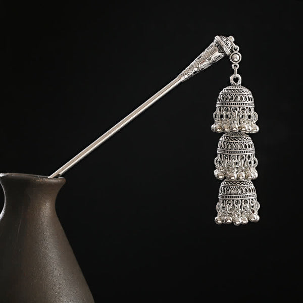 Bells variant triple bell tassel on black vase background