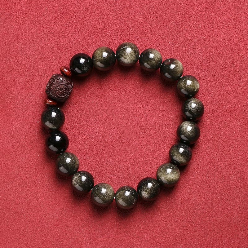 Gold Sheen & Rainbow Obsidian Fu Bracelet – flat lay on solid red background, gold obsidian beads