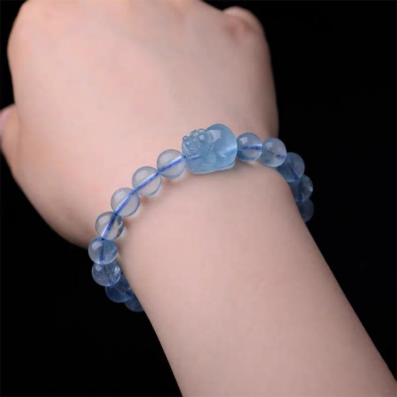 Natural Aquamarine PiXiu Serenity Bracelet – Wrist wearing aquamarine PiXiu bracelet against black background, calm jewelry