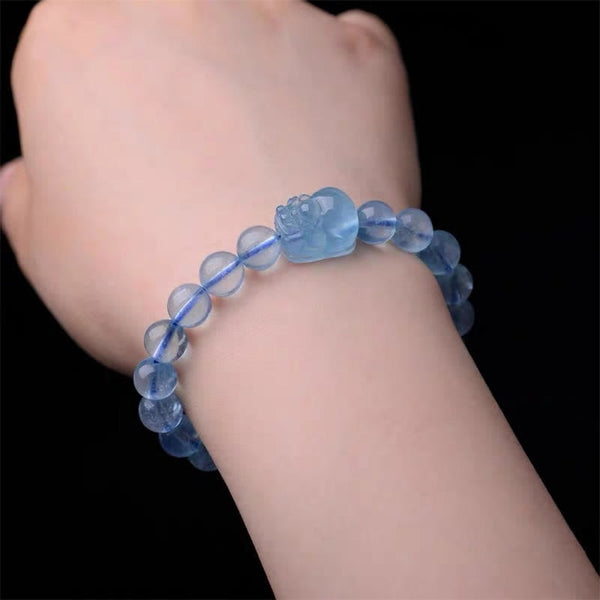 Natural Aquamarine PiXiu Serenity Bracelet – Wrist wearing aquamarine PiXiu bracelet against black background, calm jewelry