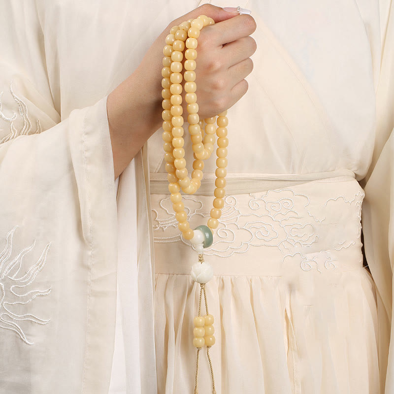 Bodhi Seed Lotus Dzi Bracelet - Mala draped over hanfu robe with embroidered clouds, meditation beads