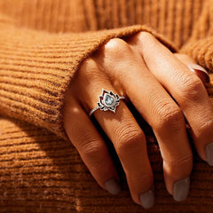 Lotus Zircon Ring – clear stone lotus on hand against knit sweater, blessing ring