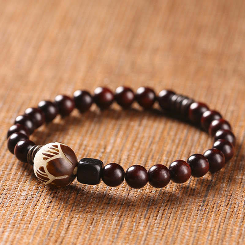 Red Sandalwood Lotus Bodhi Seed Bracelet – Dark wood beads with lotus carving and black spacers on natural linen fabric