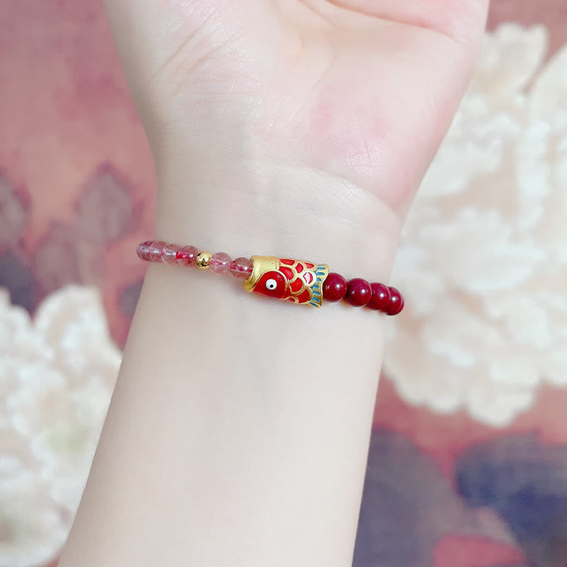 Strawberry Quartz Koi Bracelet – cinnabar bead close-up under warm lighting showing rich red hue
