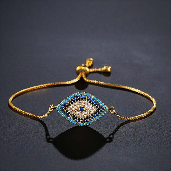 Evil Eye Healing Bracelet – Gold tone bracelet with navy turquoise evil eye on dark gray background