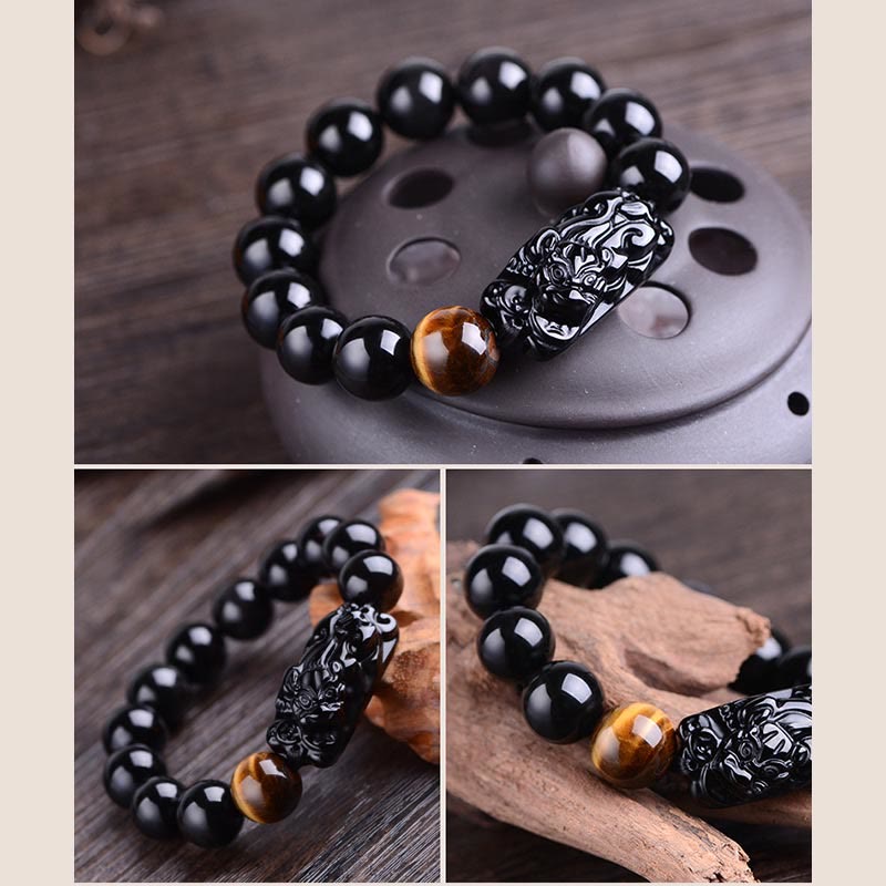 Natural Black Obsidian PiXiu Tiger Eye Bracelet macro shot, carved Pixiu relief, amber bead accent, wealth charm