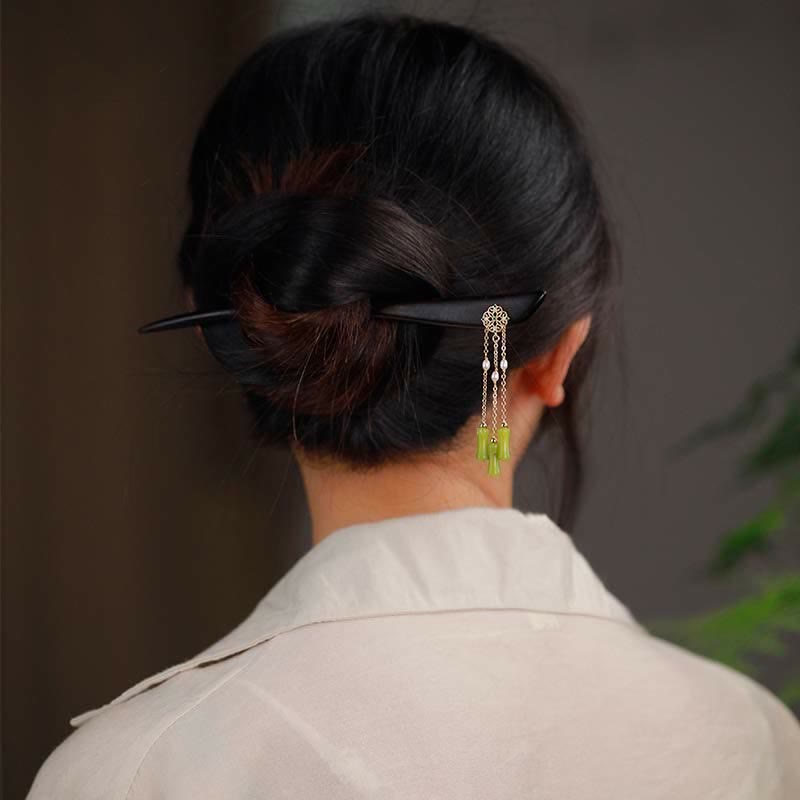 Peridot Ebony Wood Hairpin, back view of hair bun styled with ebony hairpin and green tassel