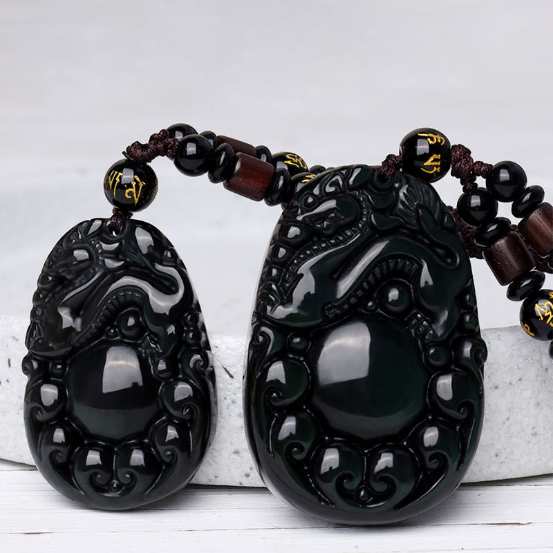 Tibetan Rainbow Obsidian PiXiu Necklace – two PiXiu pendants side by side on white background showing glossy finish, wealth talisman