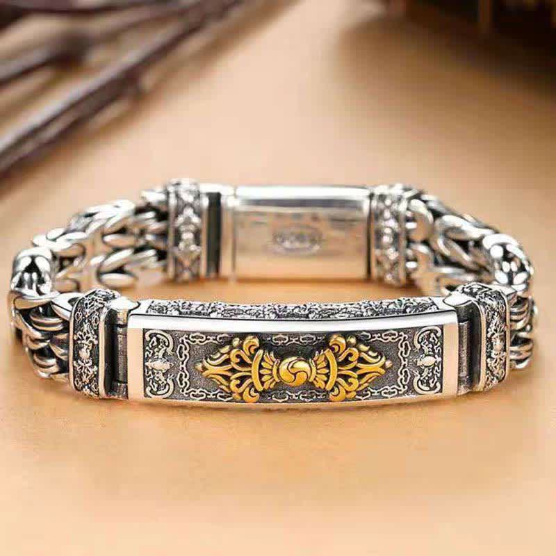 Vajra Dorje Copper Balance Bracelet - twisted braided copper chain bracelet with gold-tone vajra dorje centerpiece, oxidized silver finish, heavy Byzantine links, flat lay on warm wood background, front view