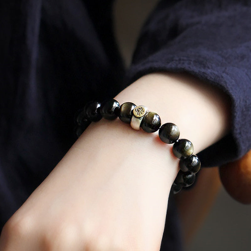 Zodiac Natal Buddha Obsidian Silver Bracelet - Close-up wrist wear with gold flash obsidian and two-tone charm