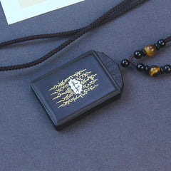 Ebony Wood Lotus Pendant – Three-quarter view on dark fabric, gold yantra, Spiritual