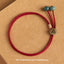 925 Silver Zodiac Natal Buddha Red String Bracelet on kraft paper, Rat Thousand-armed Avalokitesvara Sanskrit charm, antique bronze medallion, teal green stone beads, burgundy adjustable cord bracelet