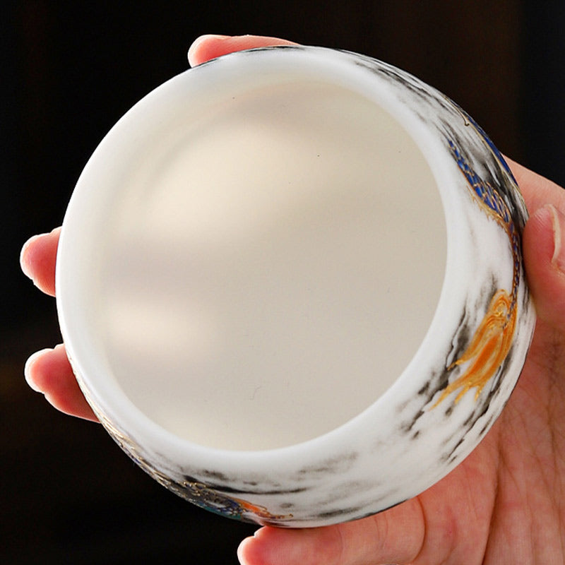 Dragon Playing Pearl Porcelain Teacup – Top-down into creamy interior with gold dragon and clouds on rim, hidden art