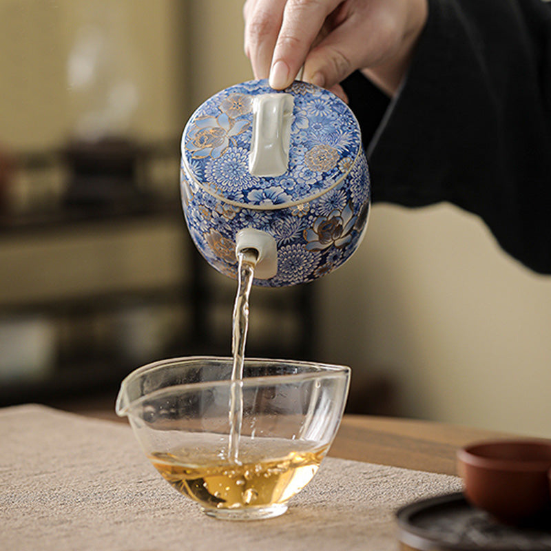 Lotus Chrysanthemum Ceramic Teapot - Pouring amber tea into glass, dynamic tea service, flowing
