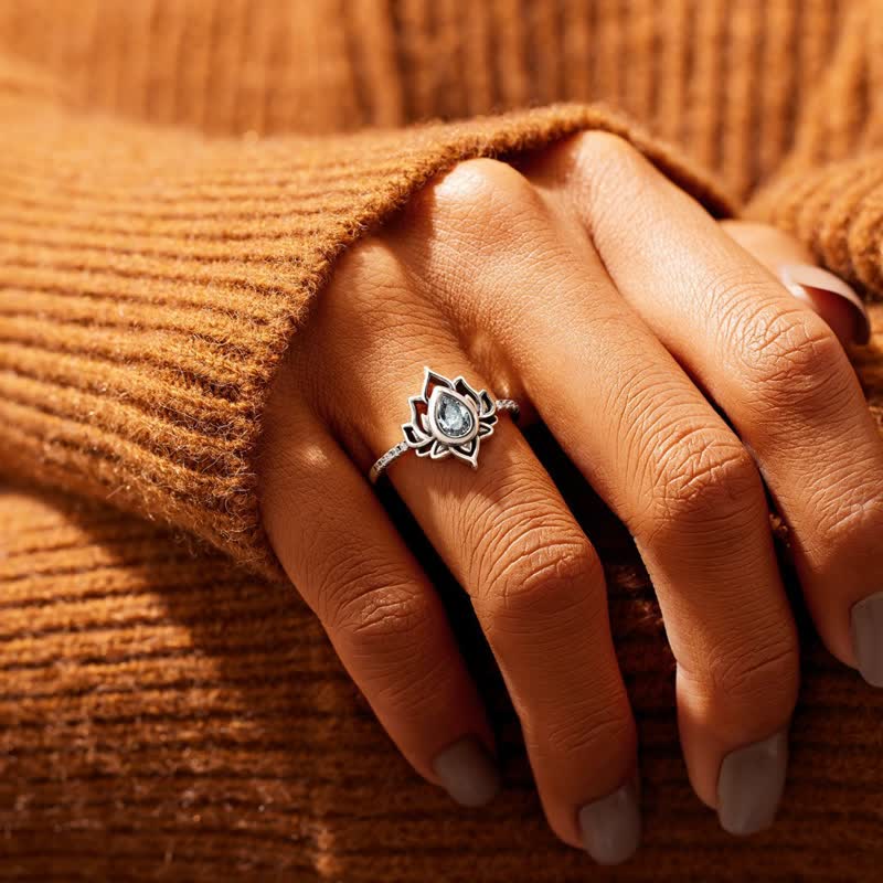 Sterling Silver Lotus Ring – Clear zircon ring on finger with autumn sweater, lotus jewelry