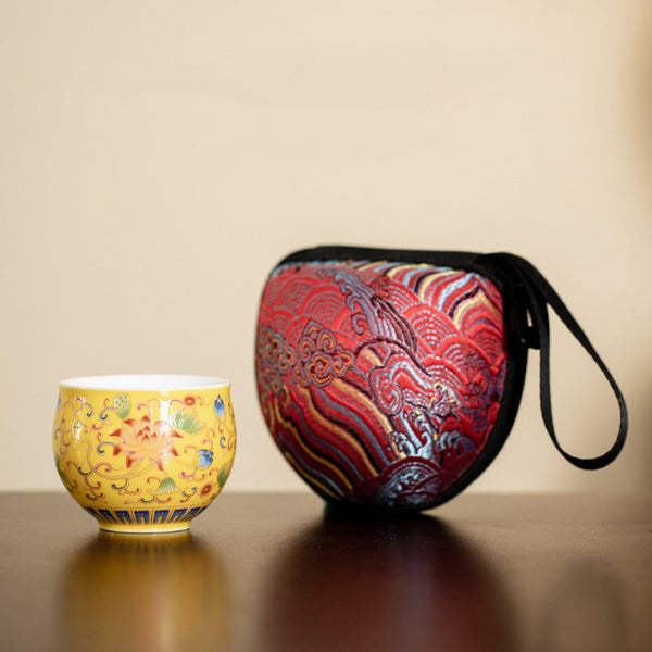 Lotus Pod Ceramic Tea Cup – yellow lotus cup beside embroidered red travel case, tea gift