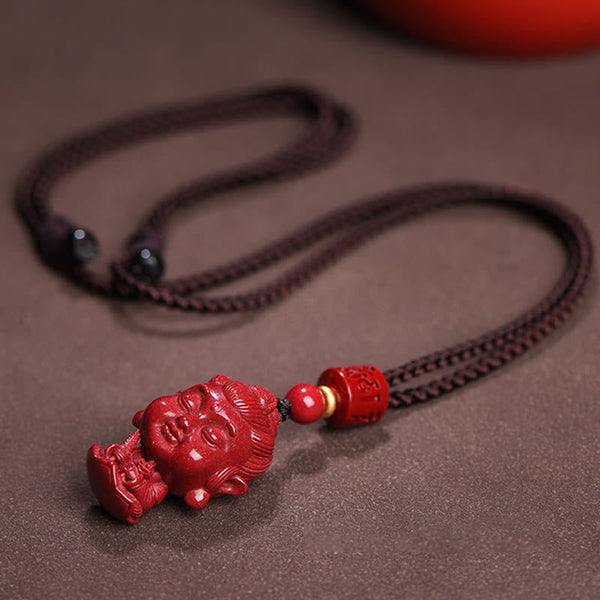 Chinese Zodiac Cinnabar Pendant – Buddha head carving with decorative beads on neutral background, natal amulet