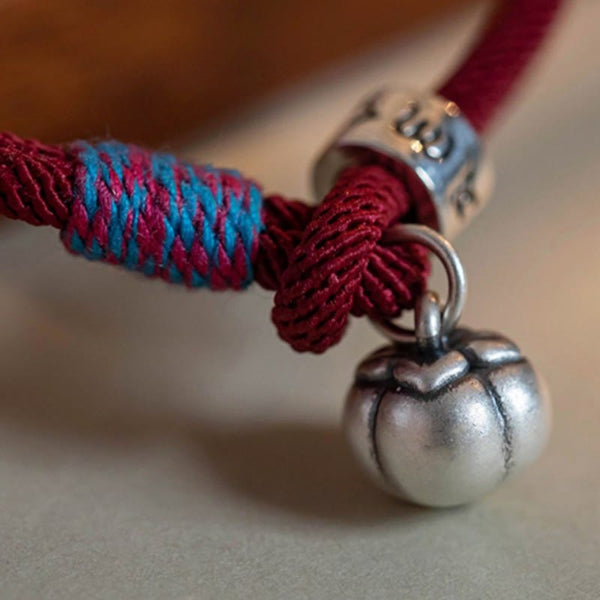 Om Mani Padme Hum Bracelet - Macro detail of burgundy cord with blue wrap and silver gourd pendant, boho jewelry