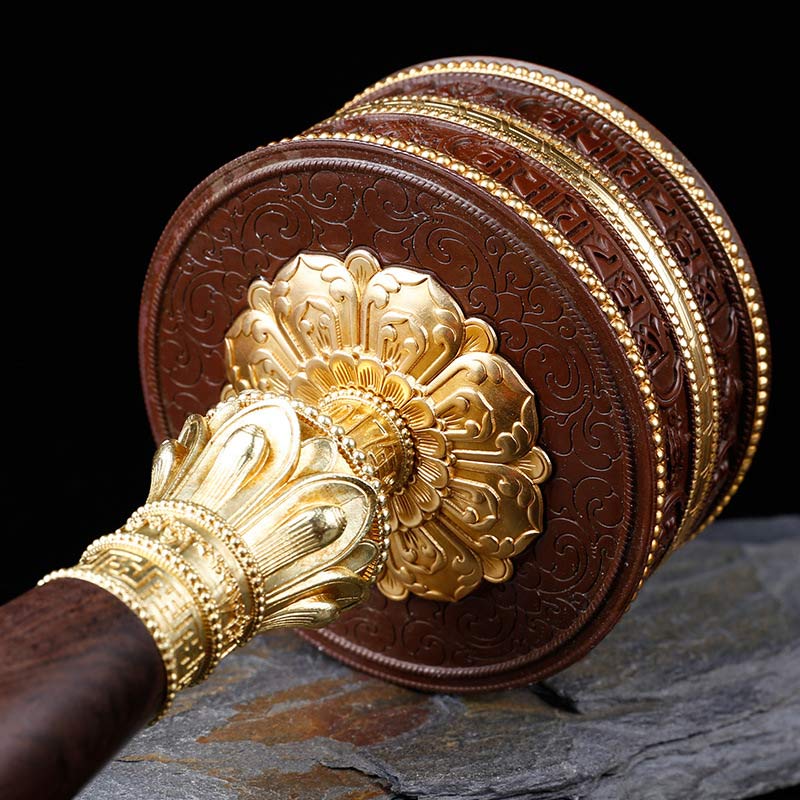 Copper Prayer Wheel – Gold lotus medallion on stone base, low angle, zen spiritual decor