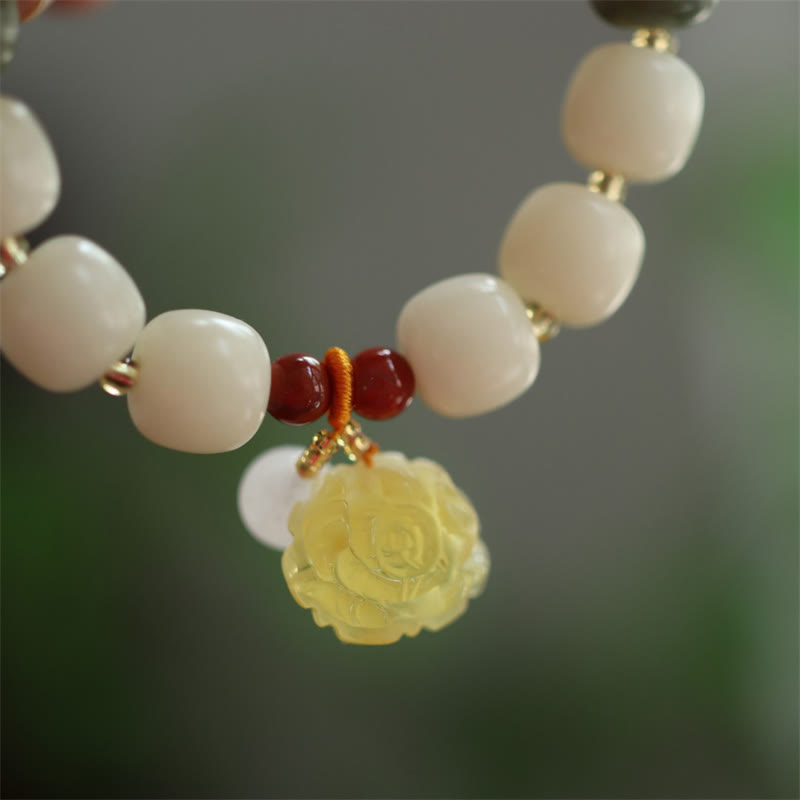 Gradient Bodhi Seed Amber Lotus Bracelet – amber lotus pendant with orange knot on white beads, Grounded