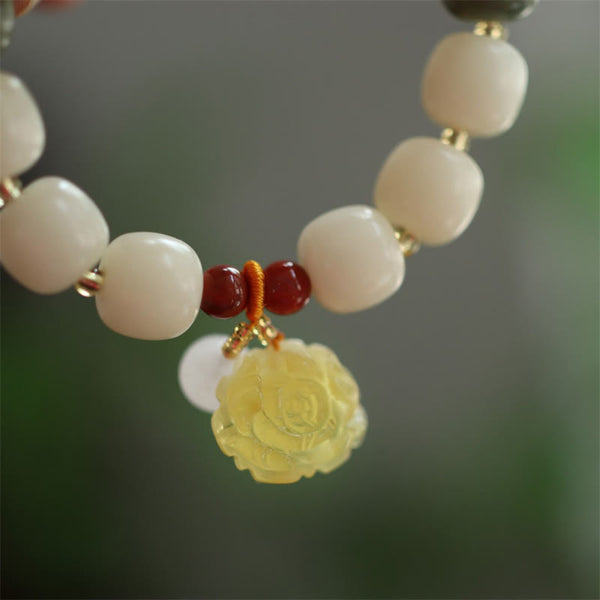 Gradient Bodhi Seed Amber Lotus Bracelet – amber lotus pendant with orange knot on white beads, Grounded
