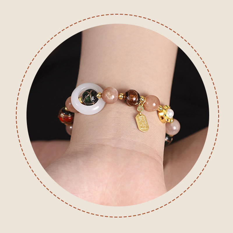 Liuli Glass Prayer Wheel Bracelet – Wrist shot in decorative frame, prayer bead bracelet on model