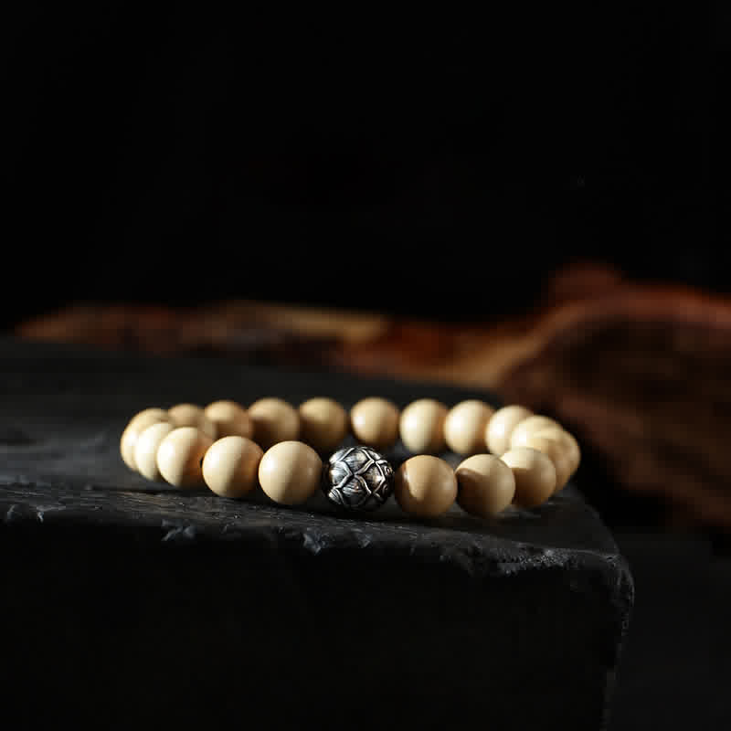 Peach Wood Cinnabar Bracelet – Geometric carved metal bead on light wood beads on slate, artisan spiritual